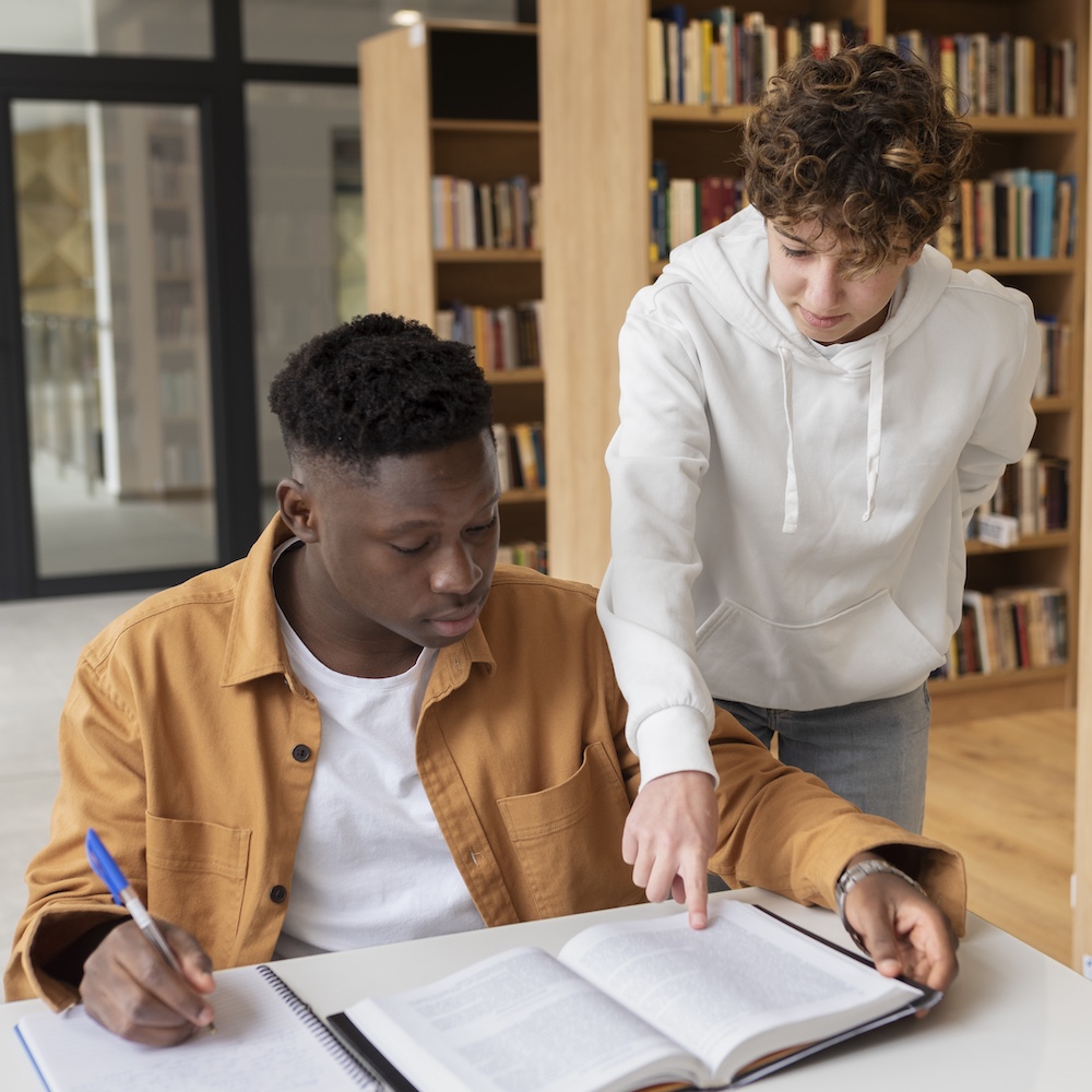 Student Helping Other Student Study in Library