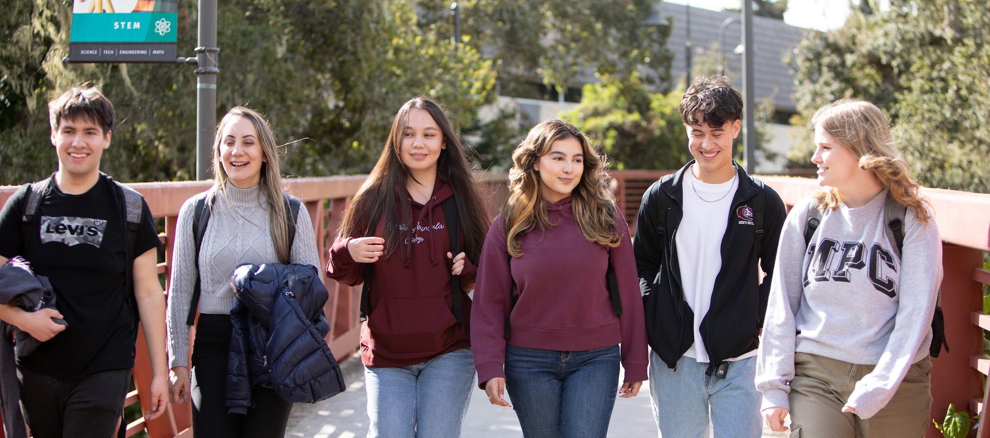 Students Walking Over Bridge on Campus