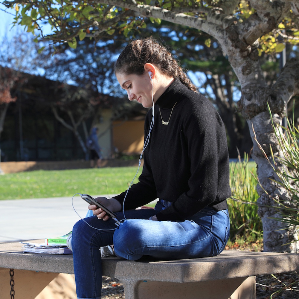 Student being counseled over phone call with earphones in