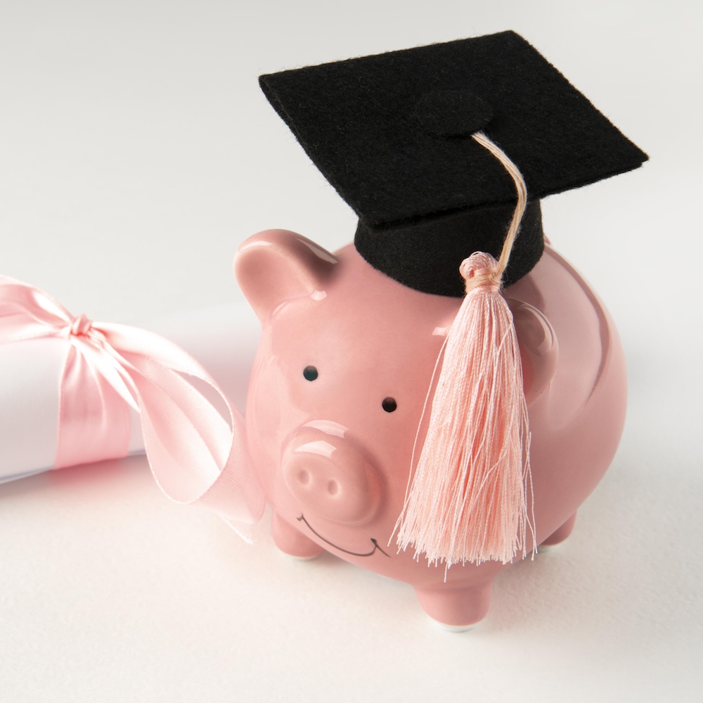 Piggy bank with grad cap and diploma