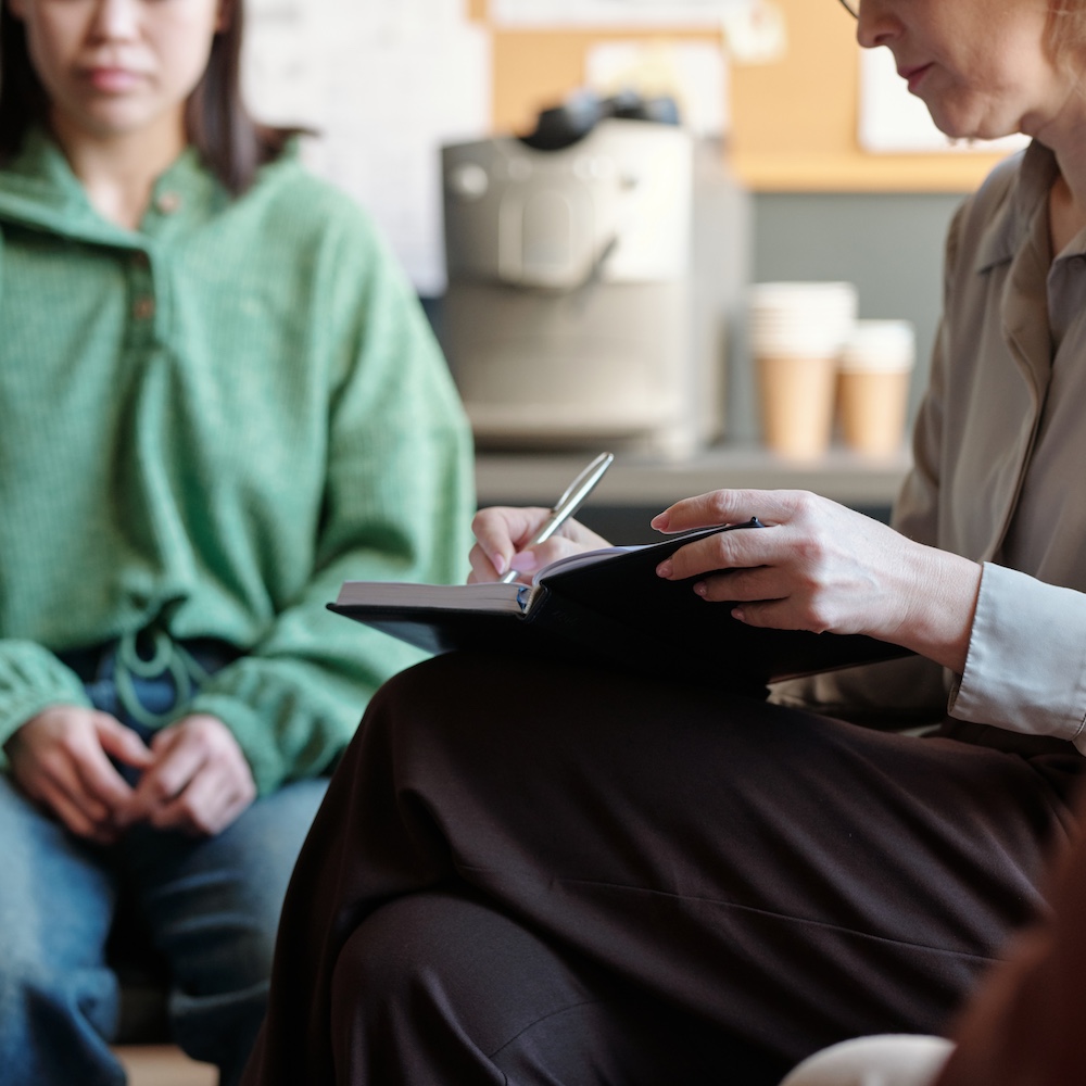 Therapist taking notes in session